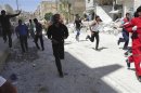 People run for cover after what activists said was shelling by forces loyal to Syria's President Bashar al-Assad in Raqqa province, eastern Syria