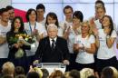The leader of Poland's main opposition party Law and Justice Kaczynski addresses as his daughter Marta looks on after the exit poll results are announced in Warsaw