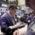 In this Feb. 28, 2012 photo, traders work on the floor of the New York Stock Exchange. Now that the Dow Jones industrial average has closed above 13,000, an all-time high is in sight — just 1,160 points away. But the coast is not quite clear for the markets or the economy.(AP Photo/Richard Drew)