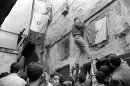 A picture taken in July 1962 shows Algerians waving flags in the casbah in Algiers