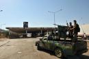 Syrian rebels stand on a vehicle at the Bab al-Hawa border post with Turkey on July 20, 2012