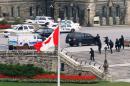 Armed RCMP officers head in to Centre Block on Parliament Hilll following a shooting incident in Ottawa