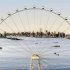 In this image released by the New York Mayor's Office, Thursday, Sept. 27, 2012 is an artist's rendering of a proposed 625-foot Ferris wheel, billed as the world's largest, planned as part of a retail and hotel complex along the Staten Island waterfront in New York. The attraction, called the New York Wheel, will cost $230 million. Officials say the observation wheel will be higher than the Singapore Flyer, the London Eye, and a "High Roller" wheel planned in Las Vegas. Beyond the wheel is the Manhattan skyline. (AP Photo/Office of the Mayor of New York)
