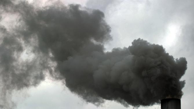 Smoke billows from a chimney of a sugar cane processing factory in Juan Vinas, on the outskirts of San Jose, Costa Rica, on April 20, 2012