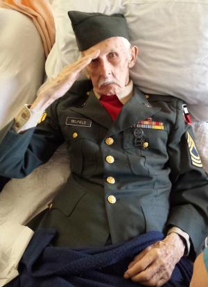 This Nov. 11, 2014 photo provided courtesy of Nancy McKiernan of Baptist Health Nursing and Rehabilitation Center in Glenville, N.Y., shows 98-year-old World War II veteran Justus Belfield saluting on Veterans Day. The Daily Gazette of Schenectady reports Belfield had worn his Army uniform every Veterans Day since he and his wife moved into the nursing home outside Albany several years ago. On Tuesday, the former master sergeant wasn't able to get out of bed to participate in the facility's Veterans Day festivities, so he had the staff dress him in his uniform. Belfield passed away the next day. (AP Photo/Courtesy of Nancy McKiernan/Baptist Health Nursing and Rehabilitation Center)