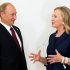 U.S. Secretary of State Hillary Rodham Clinton, right, talks with Russian President Vladimir Putin during the arrival ceremony for the Asia-Pacific Economic Cooperation (APEC) Summit in Vladivostok, Russia, Saturday, Sept. 8, 2012. (AP Photo/Jim Watson, Pool)