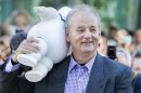 Actor Bill Murray carries a marshmallow doll he received from a fan as he arrives to the gala presentation for the film 'Hyde Park on Hudson' during the 37th Toronto International Film Festival