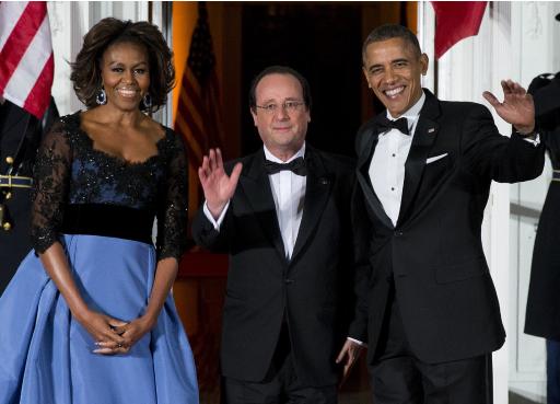 First lady Michelle Obama, left, and President Barack Obama welcome French President François Hollande for a State Dinner at the North Portico of the White House on Tuesday, Feb. 11, 2014, in Washington. Lauding the "enduring alliance" between the United States and France, President Barack Obama on Tuesday welcomed President Francois Hollande to the White House for a lavish state visit. The highly anticipated trip is taking place amid swirling speculation on both sides of the Atlantic about problems in Hollande's personal life. (AP Photo/ Evan Vucci)