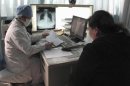 A doctor checks the progress of a patient with tuberculosis at the Beijing Chest Hospital