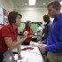FILE - In this July 13, 2011 photo, Halliburton human resource associates Heather Hopkins, left, and Sonja Franks, center rear, meet with attendees at a National Career Fairs job fair, in Dallas. Halliburton is reporting that its net income jumped nearly 50 percent in the final three months of 2011 as rising oil prices sparked new drilling projects. (AP Photo/Tony Gutierrez, file)