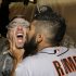 Sergio Romo kisses Marco Scutaro as they are sprayed with champagne in the locker room as San Francisco Giants celebrate after the Giants defeated the Detroit Tigers, 4-3, in Game 4 of baseball's World Series  Sunday, Oct. 28, 2012, in Detroit. The Giants won the World  Series 4-0. (AP Photo/David J. Phillip)