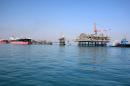 Oil tankers dock at a floating platform on September 21, 2014, offshore from the southern Iraqi port city of Al Faw