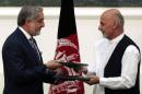 Afghan rival presidential candidates Abdullah Abdullah and Ashraf Ghani exchange signed agreements for the country's unity government in Kabul