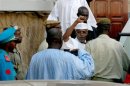 Former Chad president Hissene Habre rises his fist as he leaves a court in Dakar
