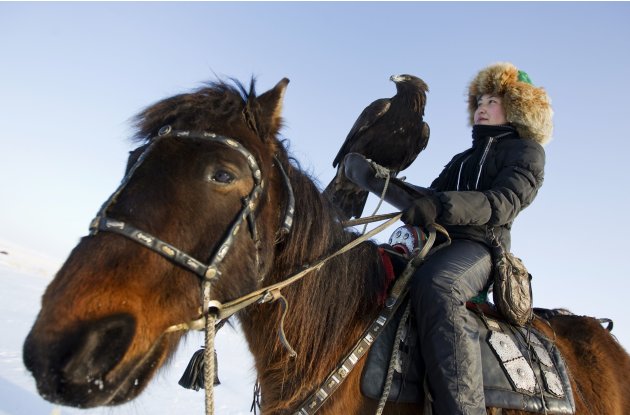 Makpal Abrazakova trains her golden eagle Akzhelke outside her home village of Aksu-Ayuly in central Kazakhstan
