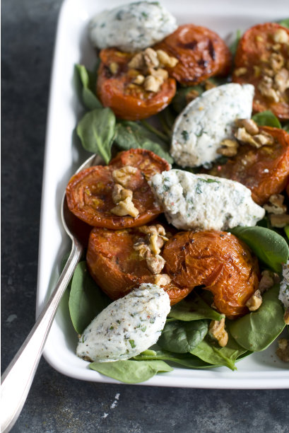 In this March 14, 2012 image taken in Concord, N.H., walnuts are featured in a composed salad made from roasted tomatoes and creamy, herbed ricotta cheese. (AP Photo/Matthew Mead)