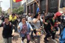 Students demonstrators shout slogans against riot policemen during a protest in Bogota
