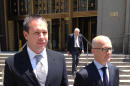 Eric Prokopi, left, of Williamsburg, Va., leaves federal court in New York, Tuesday, June 3, 2014, after he was sentenced to three months in prison for illegally importing a 70 million-year-old dinosaur skeleton into the United States from Mongolia. The assembled Tyrannosaurus skeleton was sold by Dallas-based Heritage Auctions for more than $1 million before it was seized by the U.S. government and returned to Mongolia. At right is his attorney, Georges Lederman. (AP Photo/Larry Neumeister)
