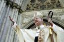 Cardinal Edward Egan waves to crowd in front of St. Patricks Cathedral during Easter Parade in New York