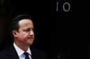 Britain's Prime Minister David Cameron waits to greet Qatar's Prime Minister Sheikh Hamad bin Jassim al-Thani at Downing Street in London