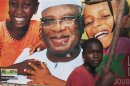 A boy sits in front of an electoral campaign poster for Malian presidential candidate Ibrahim Boubacar Keita in Timbuktu