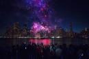 Spectators watch Macy's Fourth of July fireworks explode over the East River in New York