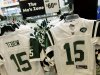 FILE - In this March 26, 2012, file photo, Reebok-branded New York Jets football jerseys with the name and number of Jets quarterback Tim Tebow are displayed at a Modell's store in New York. Reebok has scrapped its effort to sell New York Jets Tim Tebow apparel, agreeing to rid stores of thousands of jerseys and T-shirts it stamped with the quarterback's name after he was traded from the Denver Broncos to the Jets last month. The terms of a settlement with Nike were disclosed Tuesday, April 10, 2012, in papers filed in U.S. District Court in Manhattan that had been signed a day earlier. (AP Photo/Mary Altaffer, File)