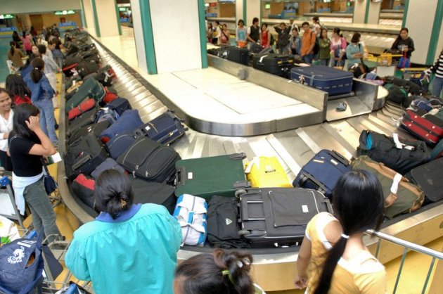 This file photo shows a group of Filipino domestic workers collecting their luggage from a carousel at Manila airport, on August 15, 2006. The Philippines is to resume sending workers to Israel as the situation there returns to normal after last month's violence, the foreign department said on Friday
