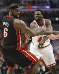 Chicago Bulls center Nazr Mohammed (48) pushes Miami Heat small forward LeBron James (6) to the floor during the first half of Game 3 of an NBA basketball playoffs Eastern Conference semifinal on Friday, May 10, 2013, in Chicago. Mohammed was ejected after this play. (AP Photo/Charles Rex Arbogast)