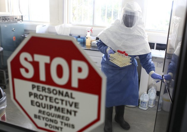 A doctor works in a laboratory on collected samples of the Ebola virus at the Centre for Disease Control in Entebbe, about 37 km (23 miles) southwest of Uganda's capital Kampala, August 2, 2012. Residents in western Uganda said on Thursday they were too scared to go shopping in local markets, visit churches or mosques or travel freely for fear of catching the Ebola virus which has already killed 16 people. REUTERS/Edward Echwalu (UGANDA - Tags: DISASTER HEALTH)