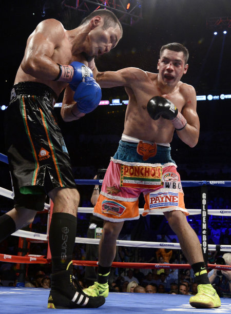 Omar Figueroa, Jr., right, hits Nihito Arakawa, of Japan, during a lightweight title boxing match, Saturday, July 27, 2013, in San Antonio. Figueroa won by decision after 12 rounds