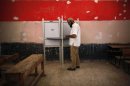A voter prepares to cast his vote at a polling station in Cairo