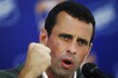 Opposition primary winner Henrique Capriles gestures as he speaks during a news conference in Caracas