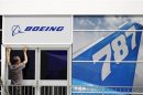 A worker prepares the Boeing chalet ahead of the Farnborough Airshow 2012 in southern England