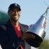 Tiger Woods hoists the championship trophy after winning the Arnold Palmer Invitational golf tournament at Bay Hill in Orlando, Fla., Sunday, March 25, 2012. (AP Photo/Phelan M. Ebenhack)