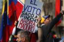A Venezuelan living in Chile holds up a sign that reads in Spanish "The vote ousted Pinocho," referring to Chile's late dictator Gen. Augusto Pinochet, "Now Maduro," during a protest against the government of Venezuela's President Nicolas Maduro in Santiago, Chile, Saturday, Sept. 3, 2016. Protesters joined their countrymen in Venezuela who have coined recent protests as "taking of Caracas" to pressure electoral authorities to allow a recall referendum against Maduro this year. (AP Photo/Esteban Felix)