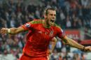 Wales midfielder Gareth Bale celebrates scoring the opening goal during the Euro 2016 qualifying group B football match in Cardiff on June 12, 2015
