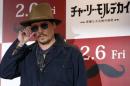 Actor Johnny Depp poses during a photo session ahead of a news conference for his movie "Mortdecai" in Tokyo