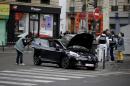 Police officers carry out investigations on a car in the 18th district of Paris on November 17, 2015, which is suspected to have been involved in the November 13, 2015 terror attacks