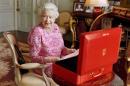 A handout photograph shows Britain's Queen Elizabeth sitting in her private audience room in Buckingham Palace next to one of her official red boxes in London