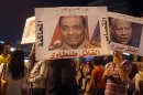 Activists from a group called "Third Square", carry posters of key former army figures as they gather to oppose both parties at Sphinx Square in Cairo