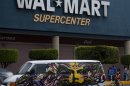 A van covered by a mural sits parked outside a Walt-Mart Super Center in Mexico City, Saturday, April 21, 2012. Wal-Mart Stores Inc. hushed up a vast bribery campaign that top executives of its Mexican subsidiary carried out to build stores across Mexico, according to a published report by the New York Times. Wal-Mart is Mexico's largest private employer. (AP Photo/Dieu Nalio Chery)