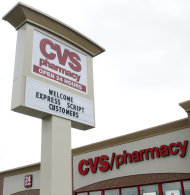 <p>               A sign at a CVS Pharmacy welcomes Express Script Customers on its sign at a store in Indianapolis, Wednesday, Feb. 8, 2012. CVS Caremark says its fourth-quarter earnings climbed nearly 4 percent, as the drugstore operator's pharmacy services revenue swelled because of a long-term contract and new business. (AP Photo/Michael Conroy)
