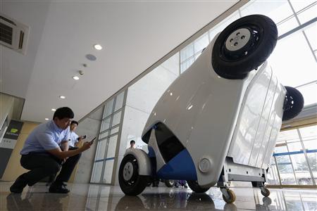 A visitor photographs Armadillo-T, a foldable electric vehicle, at Korea Advanced Institute of Science and Technology in Daejeon