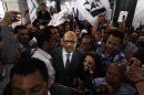 The Nobel Peace laureate Mohamed El Baradei, center, surrounded by his supporters upon his arrival to the journalists syndicate for holding a presser to launch his new Constitution political party in Cairo, Egypt, Saturday, April 28, 2012. Reform leader Mohammed ElBaradei has returned to Egypt's public political life to launch a new political party which he says aims to unite Egyptians, and salvage the revolution from a messy democratic transition. (AP Photo/Khalil Hamra)