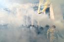 Smoke rises from the parliament building in Kiev as activists from radical Ukrainian parties, including the nationalist party Svoboda (Freedom), clash with police officers on August 31, 2015