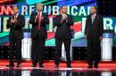 Republican presidential candidates, Sen. Marco Rubio, R-Fla, from left, Donald Trump, Sen. Ted Cruz, R-Texas, and Ohio Gov. John Kasich stand up for the national anthem during a presidential debate at the University of Miami in Coral Gables, a suburb of Miami on Thursday, March 10, 2016. (Pedro Portal/The Miami Herald via AP) MANDATORY CREDIT