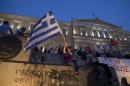 A woman waves a Greek flag during an anti-austerity pro-government rally in front of the parliament building in Athens