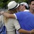 Rory McIlroy, of Northern Ireland, kisses tennis player Caroline Wozniacki after his first round of the Masters golf tournament Thursday, April 11, 2013, in Augusta, Ga. (AP Photo/David Goldman)