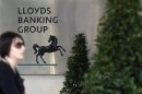 A pedestrian passes the head office of Lloyds Banking Group in central London